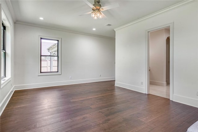 empty room with ornamental molding, a ceiling fan, arched walkways, and visible vents