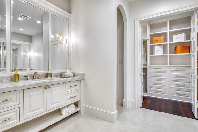 bathroom featuring recessed lighting, vanity, visible vents, and baseboards