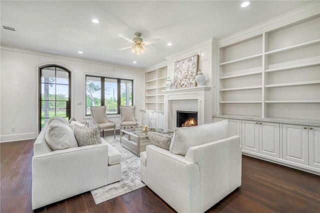living room with baseboards, ornamental molding, visible vents, and recessed lighting