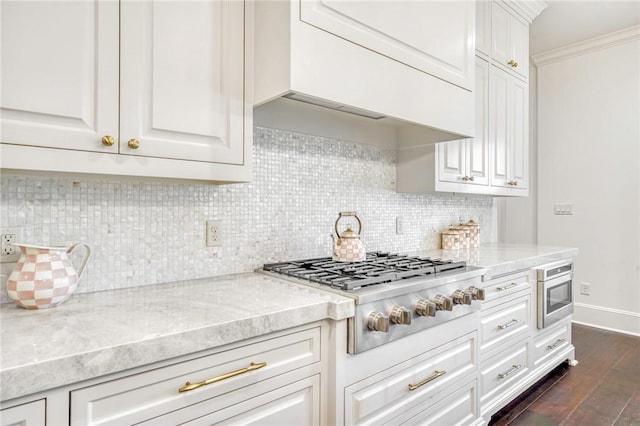 kitchen with custom range hood, baseboards, dark wood finished floors, decorative backsplash, and stainless steel gas stovetop