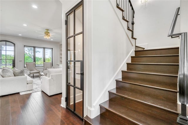 stairway featuring recessed lighting, a ceiling fan, crown molding, and wood finished floors