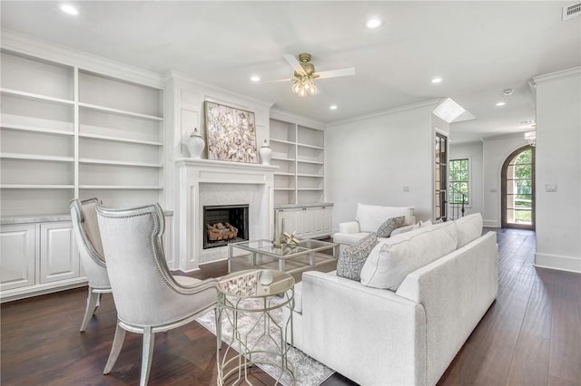 living area featuring dark wood-style flooring, baseboards, recessed lighting, a fireplace, and a ceiling fan