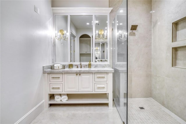 bathroom featuring a tile shower and vanity