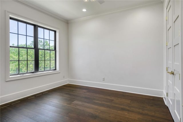 spare room featuring ornamental molding, baseboards, dark wood finished floors, and recessed lighting