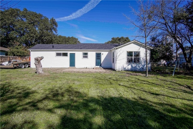 back of house featuring a yard