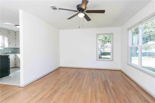 spare room featuring ceiling fan and light wood-type flooring