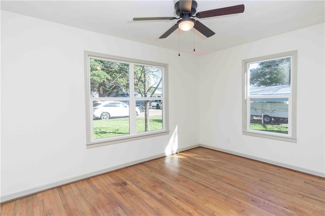 spare room featuring hardwood / wood-style floors and ceiling fan