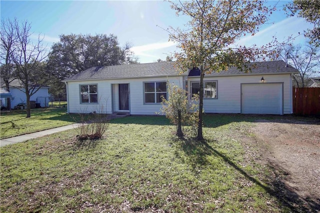 ranch-style house featuring a garage and a front lawn