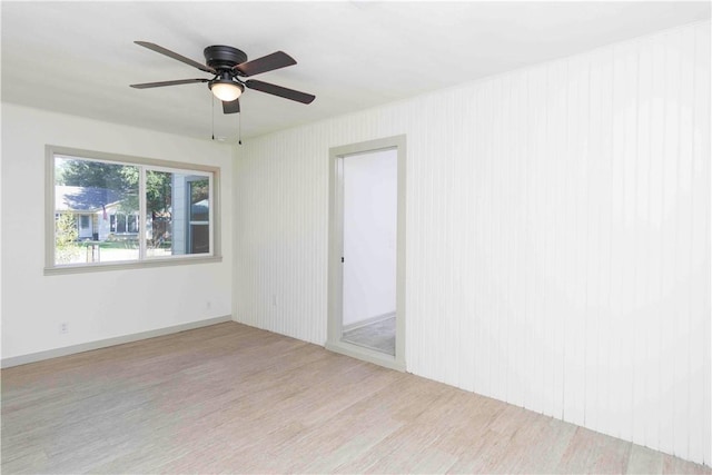 unfurnished room with ceiling fan and light wood-type flooring