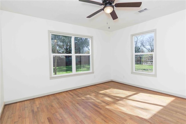 empty room featuring hardwood / wood-style floors and ceiling fan