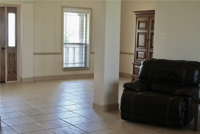 10175 Steep Hollow Rd, Bryan, TX 77808 - living area with healthy amount of natural light, wainscoting, baseboards, and light tile patterned floors