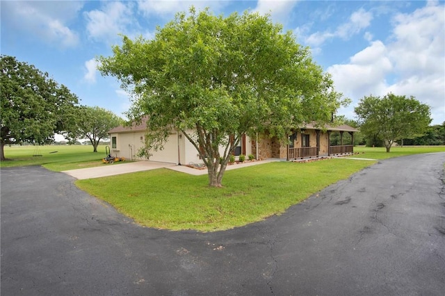 10175 Steep Hollow Rd, Bryan, TX 77808 - view of front of home featuring a front yard, concrete driveway, a porch, and an attached garage