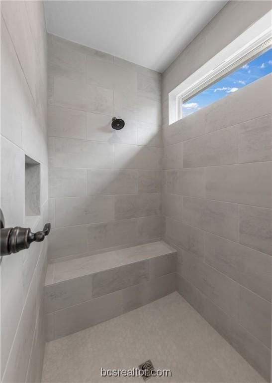 bathroom with tiled shower