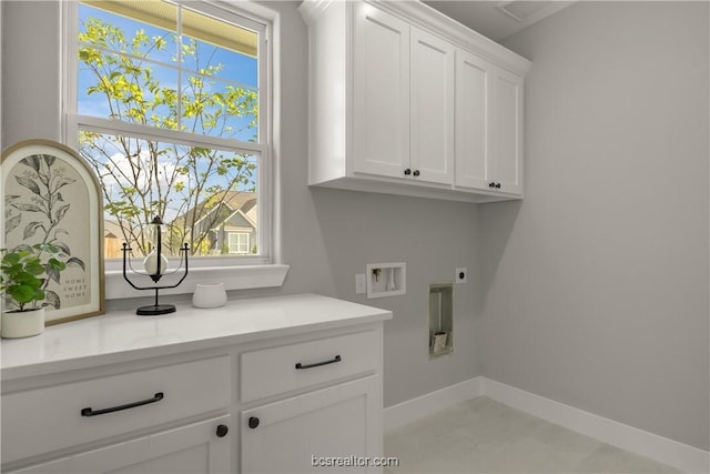 laundry area featuring washer hookup, plenty of natural light, cabinets, and electric dryer hookup