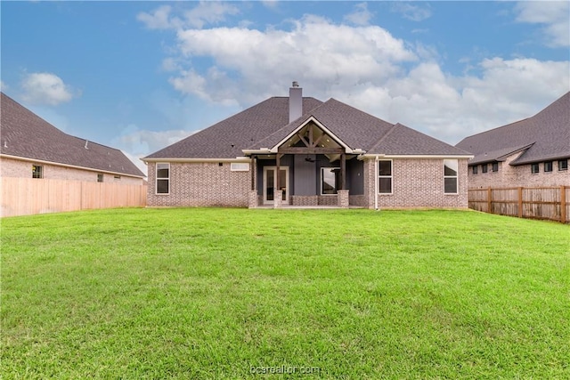 back of house with a lawn