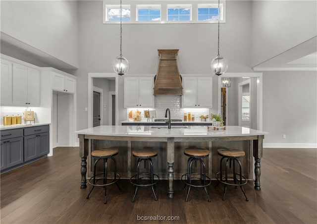 kitchen with decorative light fixtures, dark hardwood / wood-style flooring, and white cabinetry