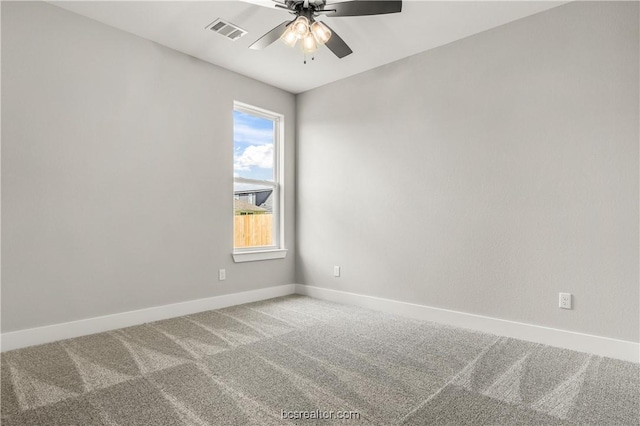 carpeted spare room with ceiling fan