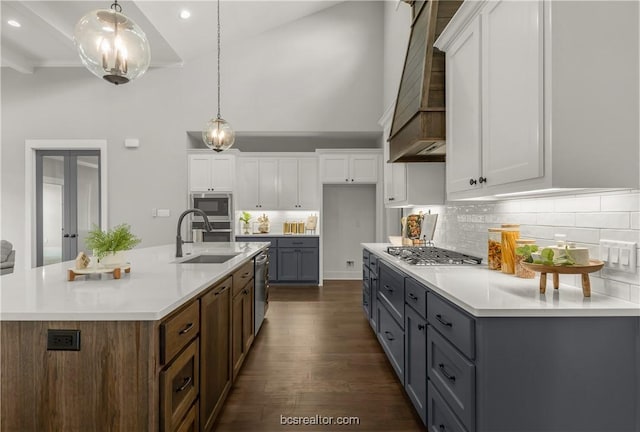 kitchen featuring white cabinets, pendant lighting, dark wood-type flooring, and sink