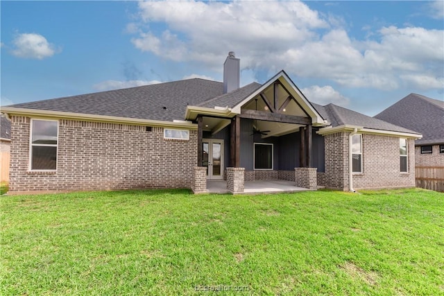 back of house with a yard, a patio, and ceiling fan