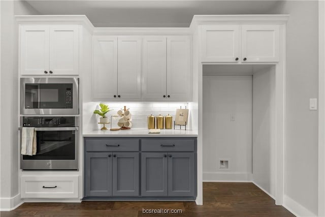 kitchen featuring stainless steel appliances, white cabinetry, tasteful backsplash, and gray cabinetry