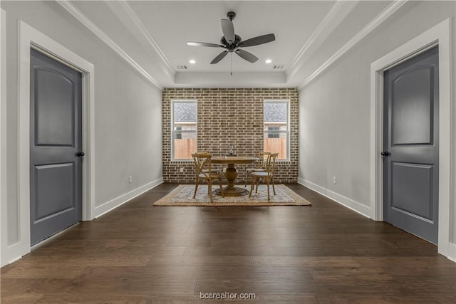 unfurnished dining area with ceiling fan, crown molding, and dark wood-type flooring