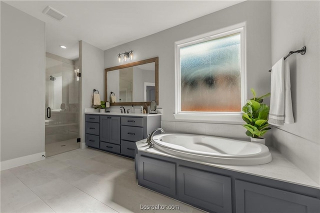 bathroom featuring tile patterned flooring, vanity, a wealth of natural light, and independent shower and bath