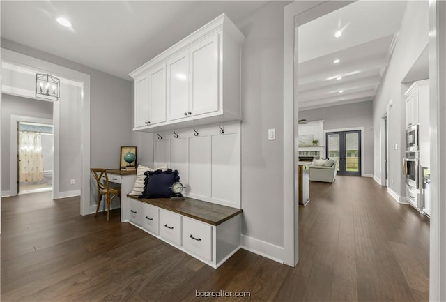 mudroom with dark hardwood / wood-style flooring and french doors