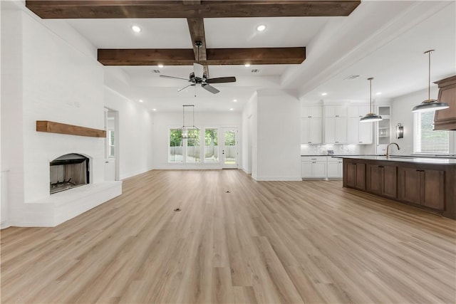 1701 Kerr Valley Ln, College Station, TX 77845 - unfurnished living room featuring beam ceiling, ceiling fan, light wood finished floors, recessed lighting, and a fireplace with raised hearth