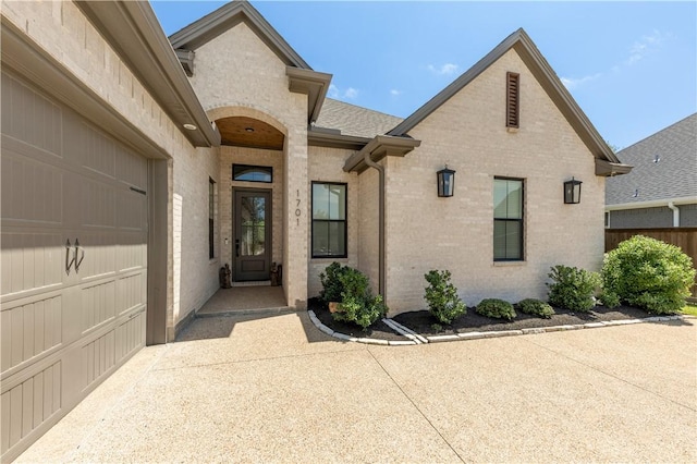 1701 Kerr Valley Ln, College Station, TX 77845 - view of exterior entry featuring brick siding and a garage