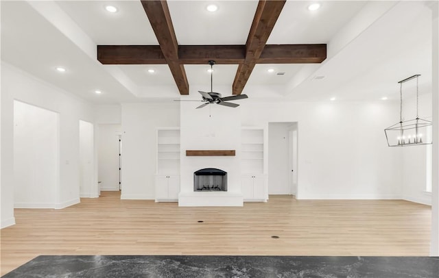 1701 Kerr Valley Ln, College Station, TX 77845 - unfurnished living room featuring a ceiling fan, light wood-style flooring, beamed ceiling, a fireplace with raised hearth, and coffered ceiling