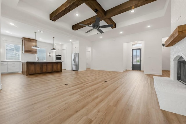 1701 Kerr Valley Ln, College Station, TX 77845 - unfurnished living room with plenty of natural light, a fireplace, recessed lighting, ceiling fan, and light wood-type flooring