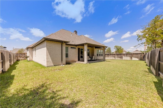1701 Kerr Valley Ln, College Station, TX 77845 - back of house featuring brick siding, a patio area, a fenced backyard, and roof with shingles