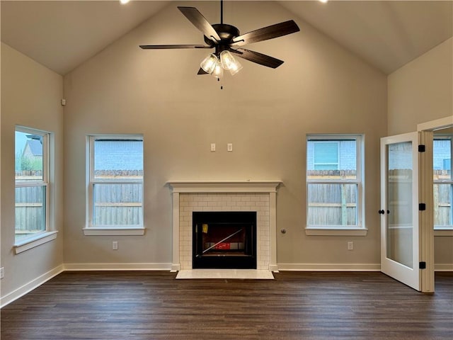 unfurnished living room with dark hardwood / wood-style floors, high vaulted ceiling, a wealth of natural light, and ceiling fan