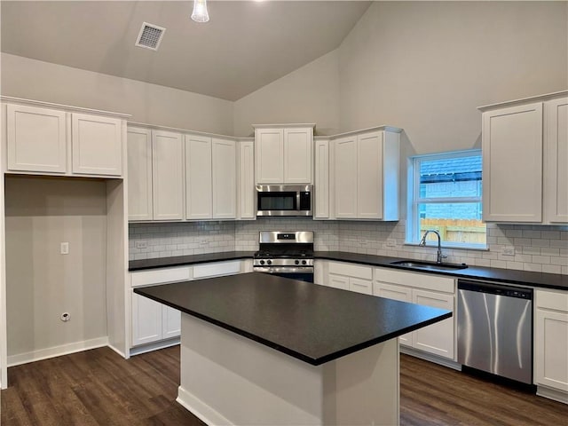 kitchen featuring sink, white cabinets, stainless steel appliances, and dark hardwood / wood-style floors