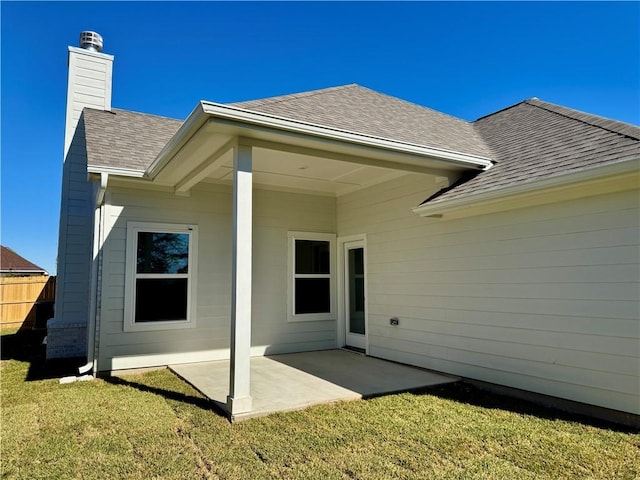 back of house with a patio area and a yard