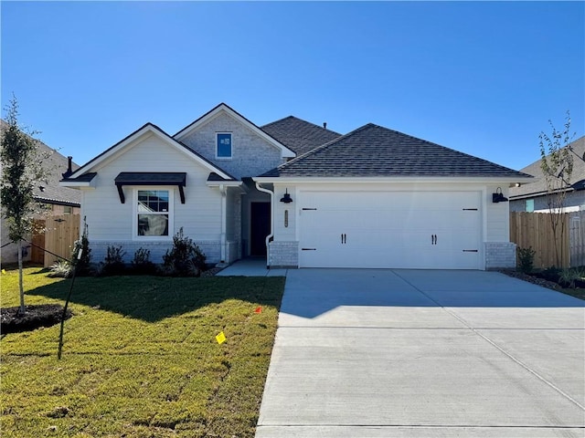 single story home featuring a garage and a front lawn