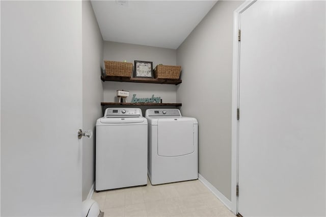 laundry area featuring baseboards, separate washer and dryer, and laundry area