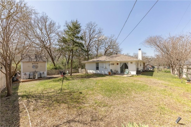 view of yard featuring an outdoor structure and fence