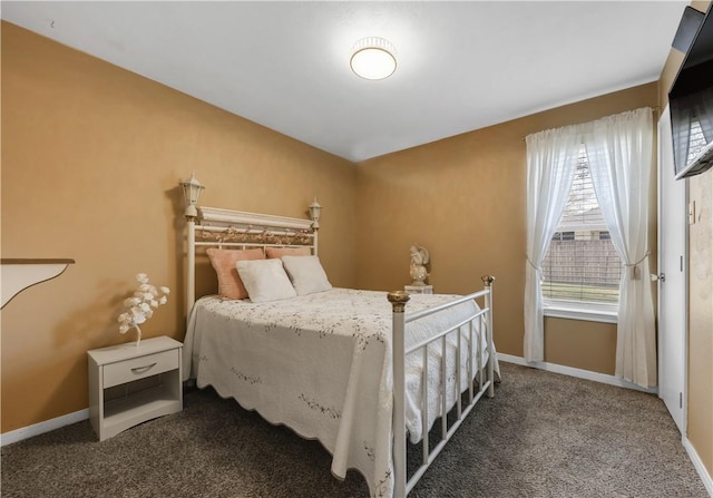 carpeted bedroom featuring baseboards