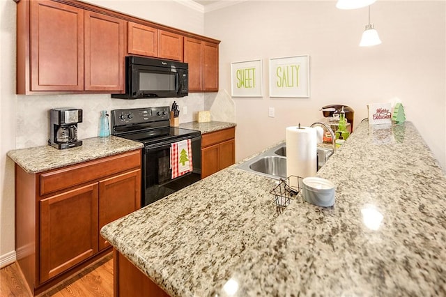 kitchen featuring light stone countertops, sink, crown molding, light hardwood / wood-style floors, and black appliances