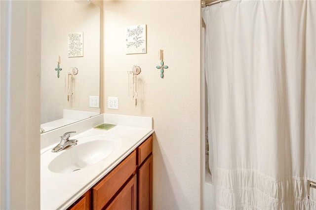 bathroom featuring vanity and shower / bathtub combination with curtain