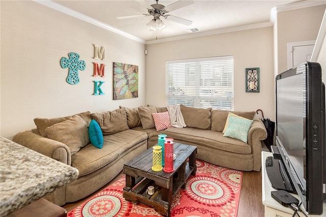 living room with wood-type flooring, ceiling fan, and crown molding