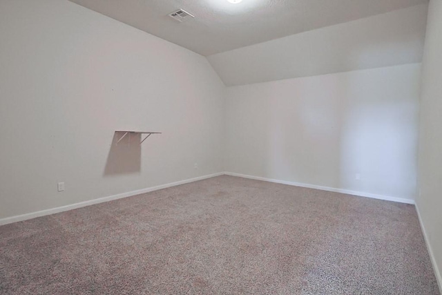 spare room with lofted ceiling and carpet floors