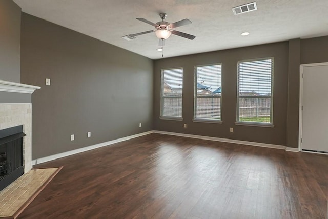 unfurnished living room with ceiling fan and dark hardwood / wood-style floors