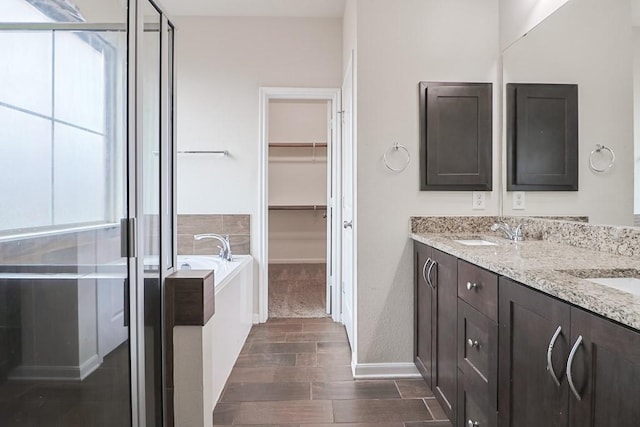 bathroom featuring vanity, a wealth of natural light, and independent shower and bath