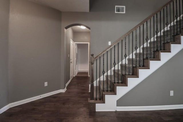 stairs featuring hardwood / wood-style floors