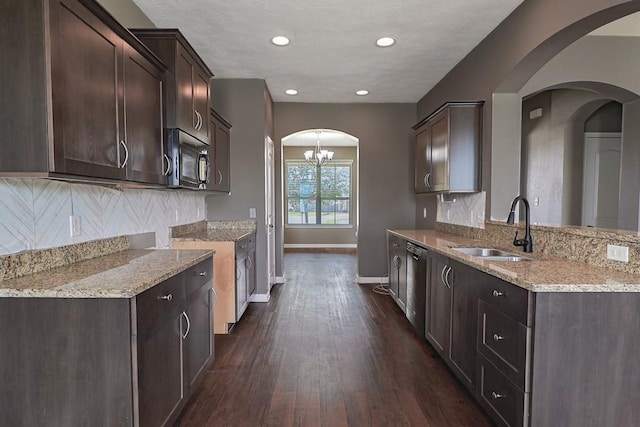 kitchen with dark brown cabinetry, sink, tasteful backsplash, dark hardwood / wood-style floors, and black appliances