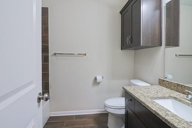 bathroom featuring vanity, hardwood / wood-style floors, and toilet