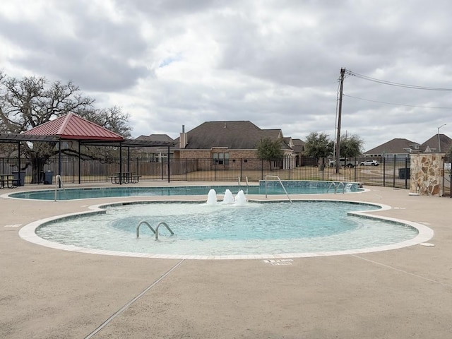 view of pool featuring a gazebo and pool water feature