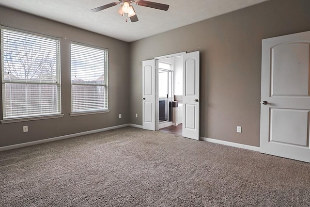 unfurnished bedroom with ensuite bathroom, carpet, and ceiling fan